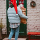 woman in a Santa hat carries a bag sack of gifts from the front door of the porch of the house. Prep woman in a Santa hat carries a bag sack of gifts from the front door of the porch of the house. Prep - PhotoDune Item for Sale