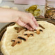 step-by-step pizza preparation, step 4, Female hands spread out the mushrooms on the pizza, step-by-step pizza preparation, step 4, Female hands spread out the mushrooms on the pizza, - PhotoDune Item for Sale
