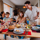 Family and friends reunion at home. Happy multigenerational family enjoying meal together at home Family and friends reunion at home. Happy multigenerational family enjoying meal together at home - PhotoDune Item for Sale