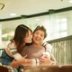 Joyful moment between family members at a cozy cafe during a sunny afternoon Joyful moment between family members at a cozy cafe during a sunny afternoon - PhotoDune Item for Sale