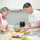 Asian senior couple preparing food together in the kitchen Asian senior couple preparing food together in the kitchen - PhotoDune Item for Sale