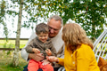 Grandmother and grandfather with grandson in a garden in autumn Grandmother and grandfather with grandson in a garden in autumn - PhotoDune Item for Sale