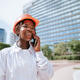 Happy black woman in helmet talking on smartphone in daylight Happy black woman in helmet talking on smartphone in daylight - PhotoDune Item for Sale