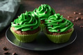 Three chocolate cupcake with green whipped cream and chocolate sprinkles on dark. St. Patrick's Day Three chocolate cupcake with green whipped cream and chocolate sprinkles on dark. St. Patrick's Day - PhotoDune Item for Sale