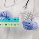 An elderly woman holds pills and an organizer in her hands. An elderly woman holds pills and an organizer in her hands. - PhotoDune Item for Sale