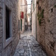 Narrow street in the old town of Trogir, Croatia Narrow street in the old town of Trogir, Croatia - PhotoDune Item for Sale
