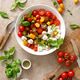 Salad with fresh cherry tomatoes, mozzarella and basil leaves, top view Salad with fresh cherry tomatoes, mozzarella and basil leaves, top view - PhotoDune Item for Sale