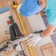 Carpenter Measures Wood Using a Saw and Tape Measure Carpenter Measures Wood Using a Saw and Tape Measure - PhotoDune Item for Sale