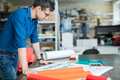 Concentrated designer thinking about paper for printing Concentrated designer thinking about paper for printing - PhotoDune Item for Sale