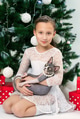 Portrait of girl 9 years old in white dress holding Sphynx Hairless Cat sits near Christmas tree Portrait of girl 9 years old in white dress holding Sphynx Hairless Cat sits near Christmas tree - PhotoDune Item for Sale