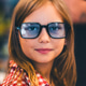 Close-up Portrait of Teenager Girl Wearing Blue Glasses with Warm Smile Close-up Portrait of Teenager Girl Wearing Blue Glasses with Warm Smile - PhotoDune Item for Sale