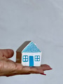 Hand of woman holding a house for real estate concept of buying a new home Hand of woman holding a house for real estate concept of buying a new home - PhotoDune Item for Sale