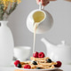 Pancakes are poured with condensed milk for breakfast. Pancakes are poured with condensed milk for breakfast. - PhotoDune Item for Sale