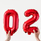 People holding red foil number balloons forming 2026 against white background People holding red foil number balloons forming 2026 against white background - PhotoDune Item for Sale