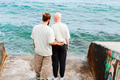 Young romantic couple in love enjoying clear blue water of sea, full length from behind Young romantic couple in love enjoying clear blue water of sea, full length from behind - PhotoDune Item for Sale