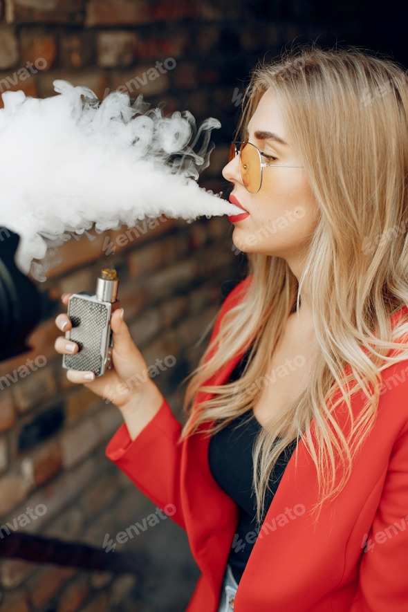 Stylish young girl in a city with vape Stock Photo by prostooleh | PhotoDune Stylish young girl in a city with vape Stock Photo by prostooleh | PhotoDune