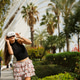 A Fashionable Young Woman is Posing Elegantly in a Lush and Beautiful Garden Setting A Fashionable Young Woman is Posing Elegantly in a Lush and Beautiful Garden Setting - PhotoDune Item for Sale