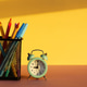 workspace with alarm clock and office supplies on yellow background. workspace with alarm clock and office supplies on yellow background. - PhotoDune Item for Sale