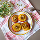 Roasted peaches and chamomile flowers on a table Roasted peaches and chamomile flowers on a table - PhotoDune Item for Sale