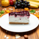 Berry cheesecake slice served on a white plate in a restaurant setting. Berry cheesecake slice served on a white plate in a restaurant setting. - PhotoDune Item for Sale