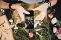 Woman florist taking pictures of flowers with mobile phone Woman florist taking pictures of flowers with mobile phone - PhotoDune Item for Sale