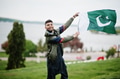 Сonfident pakistani indian muslim arabic boy in grey kameez shalwar suit with Pakistan flag. Сonfident pakistani indian muslim arabic boy in grey kameez shalwar suit with Pakistan flag. - PhotoDune Item for Sale