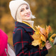 A beautiful woman smiles at the camera with a bouquet of autumn leaves. Autumn mood A beautiful woman smiles at the camera with a bouquet of autumn leaves. Autumn mood - PhotoDune Item for Sale