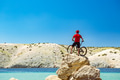 Mountain biker looking at mountains and beach Mountain biker looking at mountains and beach - PhotoDune Item for Sale