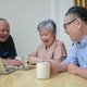 Group of mature friends discussing ideas at a table Group of mature friends discussing ideas at a table - PhotoDune Item for Sale