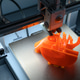 3D Printer Creating Vibrant Orange Prototype Model 3D Printer Creating Vibrant Orange Prototype Model - PhotoDune Item for Sale