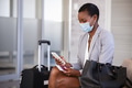 Business woman in airport with face mask checking phone Business woman in airport with face mask checking phone - PhotoDune Item for Sale