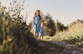 Two sisters walking in summer park with scenic path. Two sisters walking in summer park with scenic path. - PhotoDune Item for Sale
