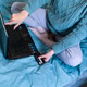 A woman makes purchases in an online store and pays for them with a card A woman makes purchases in an online store and pays for them with a card - PhotoDune Item for Sale
