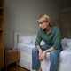 Middle aged woman sits on bed with exhausted expression, coping with depression and life crisis. Middle aged woman sits on bed with exhausted expression, coping with depression and life crisis. - PhotoDune Item for Sale
