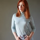 Redhead woman posing confidently in a light blue turtleneck and jeans Redhead woman posing confidently in a light blue turtleneck and jeans - PhotoDune Item for Sale