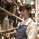 Young woman in apron scanning items on tablet in a store with shelves of goods Young woman in apron scanning items on tablet in a store with shelves of goods - PhotoDune Item for Sale