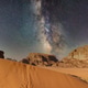 Wadi Rum desert, Jordan. Stars shine over desert landscape with sand dunes, mountains in night sky Wadi Rum desert, Jordan. Stars shine over desert landscape with sand dunes, mountains in night sky - PhotoDune Item for Sale