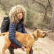 Curly hair and mountaineer woman and her dog posing outdoor during his walk through the mountains. Curly hair and mountaineer woman and her dog posing outdoor during his walk through the mountains. - PhotoDune Item for Sale