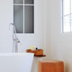 interior of modern bathroom with white bathtub and brown stool interior of modern bathroom with white bathtub and brown stool - PhotoDune Item for Sale