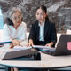Senior woman and young businesswoman reviewing and discussing documents together Senior woman and young businesswoman reviewing and discussing documents together - PhotoDune Item for Sale
