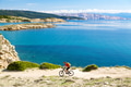 Mountain biker riding on bike in summer sunset woods Mountain biker riding on bike in summer sunset woods - PhotoDune Item for Sale