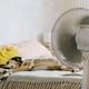 spotted Dog is lying on the bed next to the fan. The fan is turned on and blows out air. spotted Dog is lying on the bed next to the fan. The fan is turned on and blows out air. - PhotoDune Item for Sale
