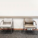 Two sleek, modern chairs with metal legs and cushioned seats sit in a minimalist waiting room Two sleek, modern chairs with metal legs and cushioned seats sit in a minimalist waiting room - PhotoDune Item for Sale