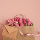 Gift Bag with Pink Tulips and Greeting Envelope on Pink Background Gift Bag with Pink Tulips and Greeting Envelope on Pink Background - PhotoDune Item for Sale