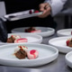 plated desserts in professional restaurant kitchen. chef arranges chocolate cake. plated desserts in professional restaurant kitchen. chef arranges chocolate cake. - PhotoDune Item for Sale