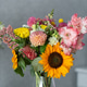 Vibrant mixed flower bouquet in glass vase with sunflower and dahlias Vibrant mixed flower bouquet in glass vase with sunflower and dahlias - PhotoDune Item for Sale