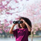 Happy African Child Looking Through Binoculars in Pink Blossom Park Happy African Child Looking Through Binoculars in Pink Blossom Park - PhotoDune Item for Sale