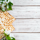 Happy Passover flatlay. Jewish matzo bread and flowers on white wooden background. Happy Passover flatlay. Jewish matzo bread and flowers on white wooden background. - PhotoDune Item for Sale