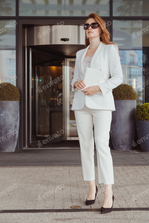 Super busy business woman wear fashion white suit and black heels