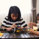 Two Asian girls working together on robotics project at home. Promoting STEM education, coding Two Asian girls working together on robotics project at home. Promoting STEM education, coding - PhotoDune Item for Sale